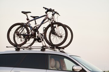 Transporting Bicycles on Car Roof for a Summer Adventure. Exploring the Open Road. Mountain bike...