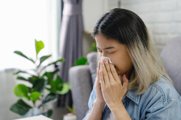 Asian woman sneezing from room dust. Allergies.