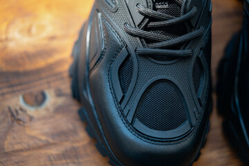 Close up of black sport shoes on wooden background
