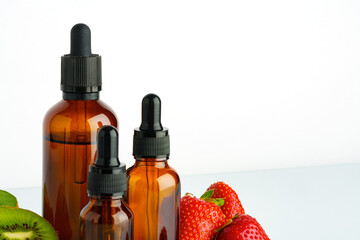 Electronic cigarette liquids with berry and kiwi flavor on white background