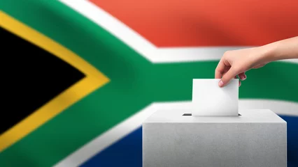 Gordijnen Woman puts ballot paper in voting box on South Africa flag background. Election concept. © ifriday