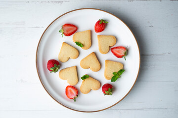 Preparing butter cookies for children with star and heart shapes.