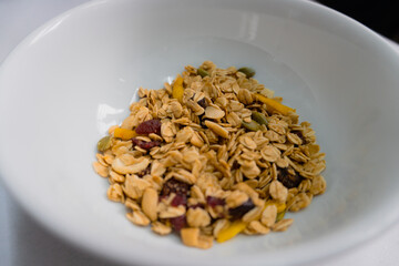 Breakfast granola with fruit in a white bowl Food photography