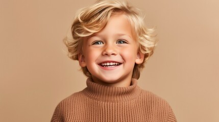 A cute, blond youngster beams with happiness against a soft beige backdrop.