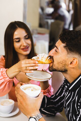 A young couple in love is having breakfast in a restaurant in a hotel. The concept of a holiday in a hotel