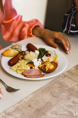A young couple in love is having breakfast in a restaurant in a hotel. The concept of a holiday in a hotel