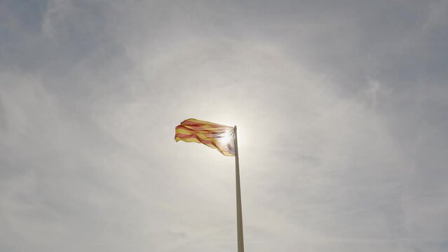 Catalan flag flying in the sky of Sant Feliu de Guises on the Costa Brava of Catalonia