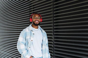Handsome young man listening to music with earphones