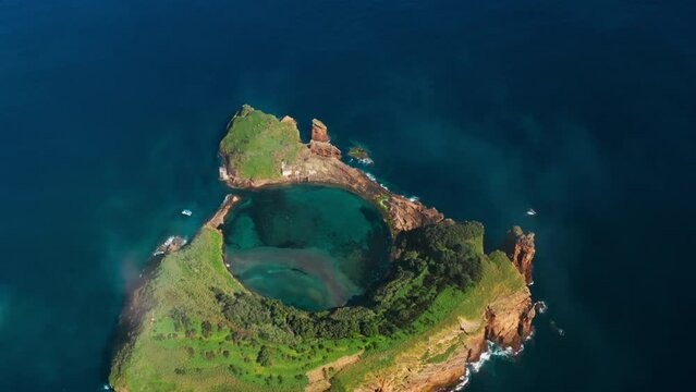 Cinematic Aerial view of Azores. Top view of the Island of Vila Franca do Campo. Crater of an old underwater volcano on Sao Miguel, Ponta Delgada Island. Portugal.