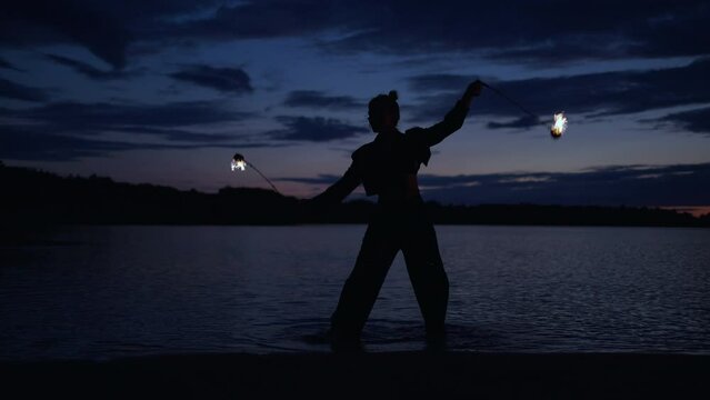 Silhouette Of Mysterious Woman Performing Tricks With Fire In Darkness, Lady Rotating Torches