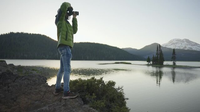 Photographer takes photos of a beautiful mountain Lake