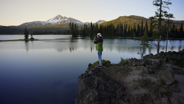 Photographer takes photos at a Scenic mountain lake