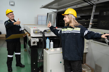 Technician caucasian woman trump up with use computer control print machine and team working...