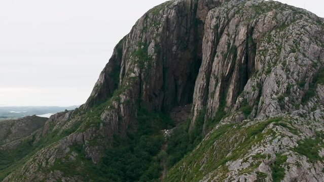 Drone flight by scenic route through mystical hole in Torghatten mountain