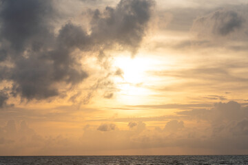 Naklejka na ściany i meble Sunset sky with clouds over the horizon over the sea, gloomy sky