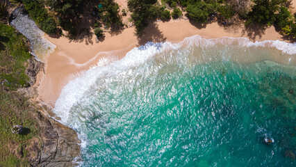Wave at a beautiful tropical white sand beach with blue sky. top view