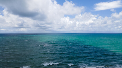 Aerial view blue sea and clouds reflection on the sea surface, natural colors, blue background