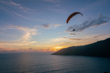 Beautiful sky sunset background and paraglider in Phuket viewpoint, The summer vacation of your travel holiday.It's happy time