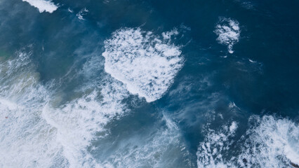 Beautiful texture of big power dark ocean waves with white wash. Aerial top view footage of fabulous sea tide on a storm