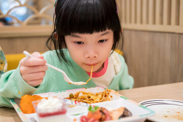 Cute little asian child girl eating food