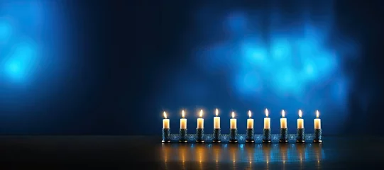 Fototapeten Lit candles at the Hanukkah festival of lights on a blue background. © Мария Фадеева