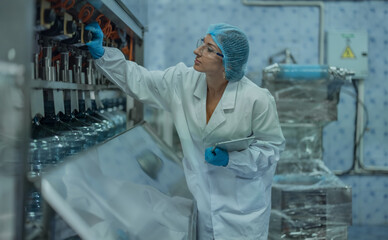 Water production QA specialist monitors and logs conveyor operations for seamless manufacturing flow