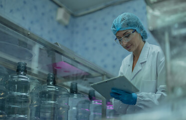 Water production QA specialist monitors and logs conveyor operations for seamless manufacturing flow