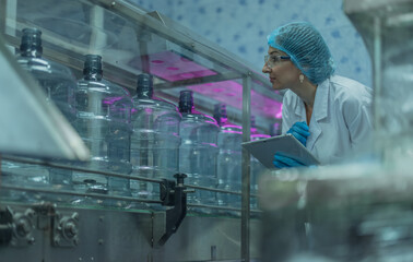 Water production QA specialist monitors and logs conveyor operations for seamless manufacturing flow