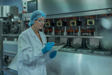 Water production QA specialist monitors and logs conveyor operations for seamless manufacturing flow