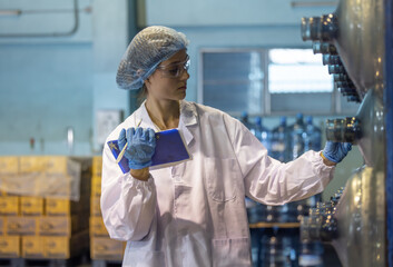 Water production QA specialist monitors and logs conveyor operations for seamless manufacturing flow