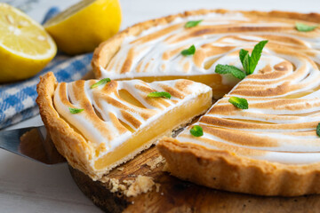 Lemon pie is a cake made up of a shortcrust or puff pastry base that is filled with lemon cream. This cake is often complemented with a meringue - obrazy, fototapety, plakaty