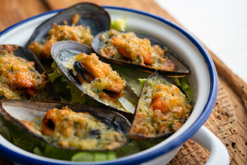 Mussels gratin. Gratin seafood dish with bread and parsley.