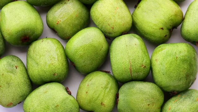 green mini kiwi (actinidia arguta), rotation in circle. baby fruit, Turning. selective focus. Seasonal fruit.