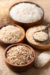 Thai brown rice seed in wooden bowl with spoon, Organic rice, Healthy food ingredient