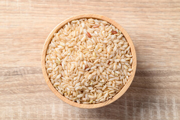 Thai brown rice seed in wooden bowl, Organic rice, Healthy food ingredient
