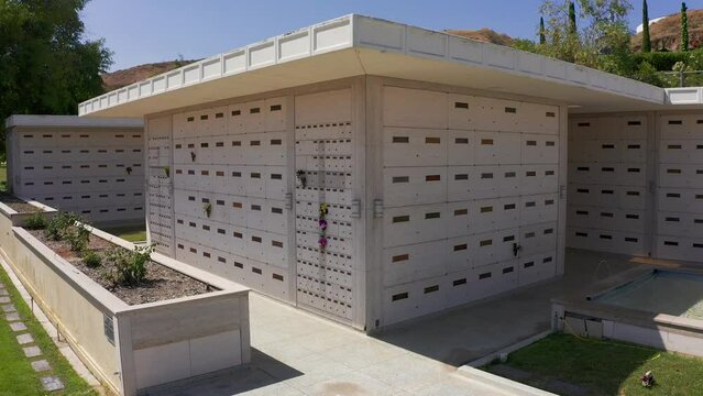 Aerial close-up panning shot of a stone mausoleum at a mortuary in California. 4K