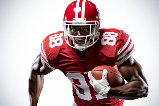 Portrait of American football player in red jersey holding ball against white background