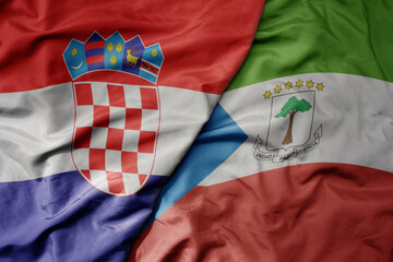 big waving national colorful flag of croatia and national flag of equatorial guinea .