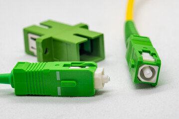 Single-mode optical patch cords with SC-APC connectors, beveled end visible at the connector,...