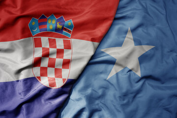 big waving national colorful flag of croatia and national flag of somalia .