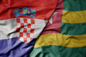 big waving national colorful flag of croatia and national flag of togo .