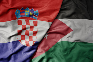 big waving national colorful flag of croatia and national flag of jordan .