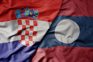 big waving national colorful flag of croatia and national flag of laos .