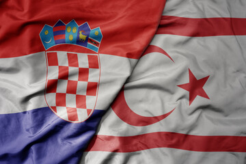 big waving national colorful flag of croatia and national flag of northern cyprus .