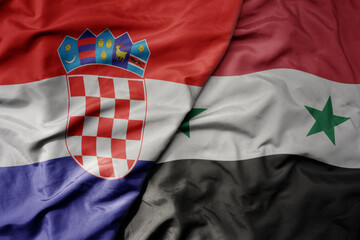 big waving national colorful flag of croatia and national flag of syria .