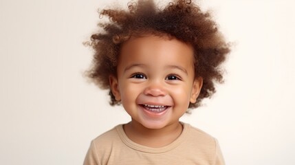 Naklejka premium A sweet toddler girl beaming with joy against a gentle beige studio setting.