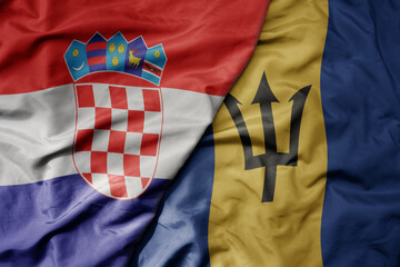 big waving national colorful flag of croatia and national flag of barbados .