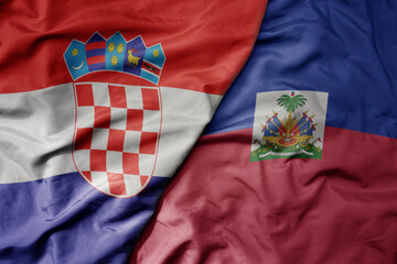 big waving national colorful flag of croatia and national flag of haiti .