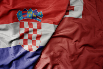 Obraz premium big waving national colorful flag of croatia and national flag of Tonga .