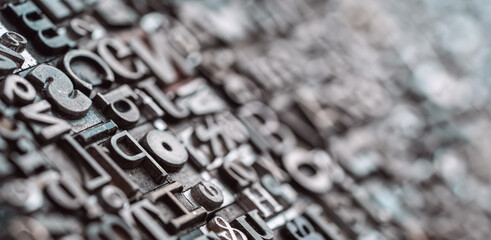 Letterpress background, close up of many old, random metal letters with copy space